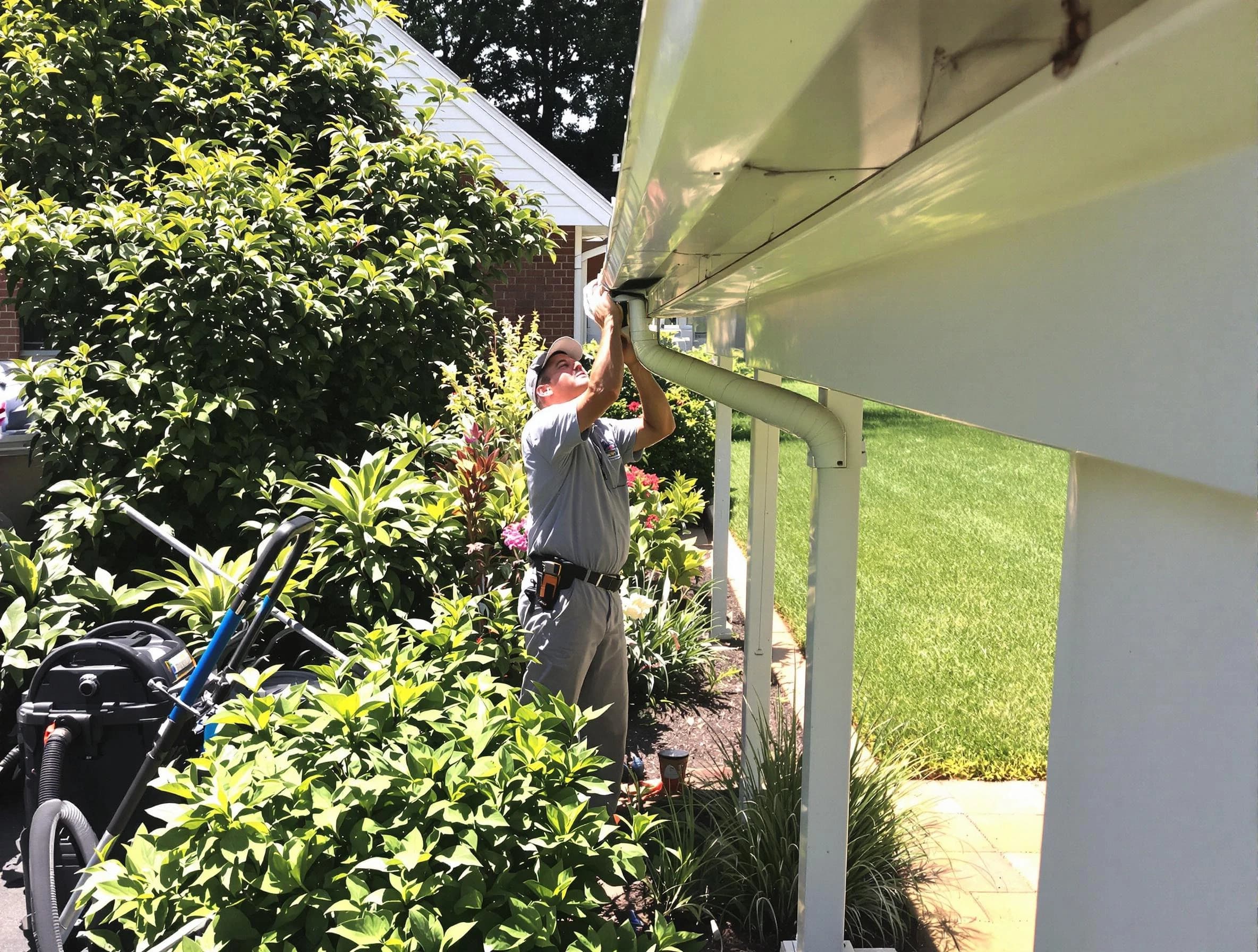 Technician flushing a blockage from a downspout in South Euclid, OH